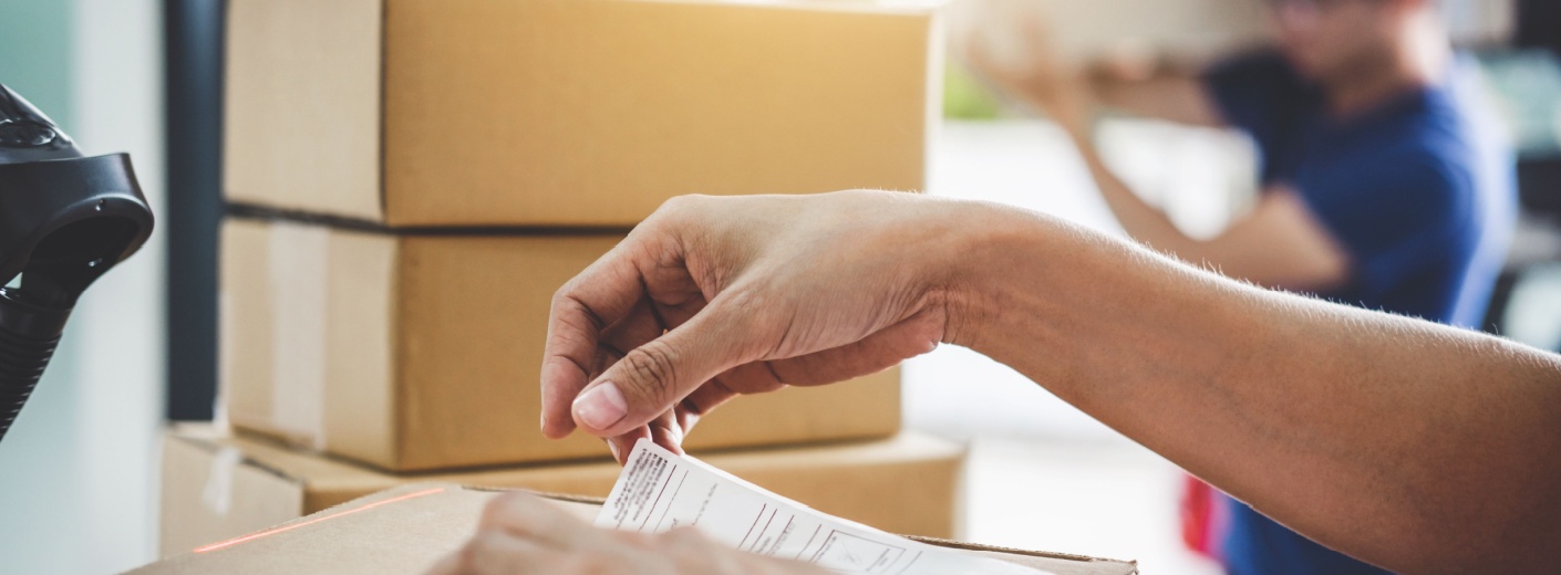 Person putting a label on a package