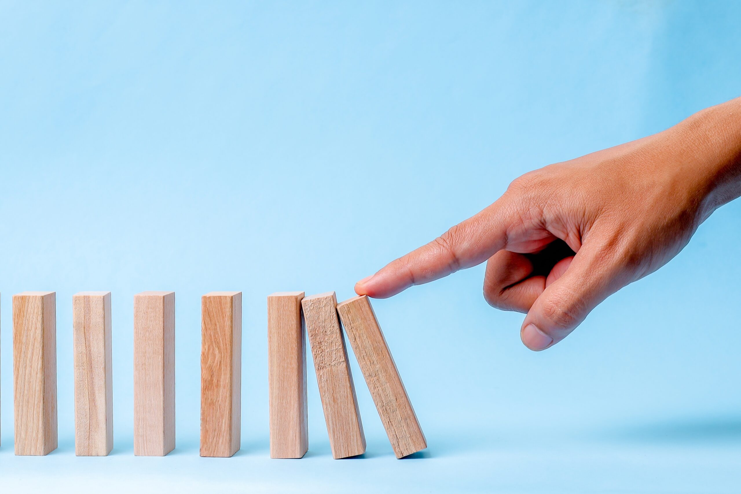 A,Finger,Pushes,The,First,Wooden,Block,,Starting,A,Domino