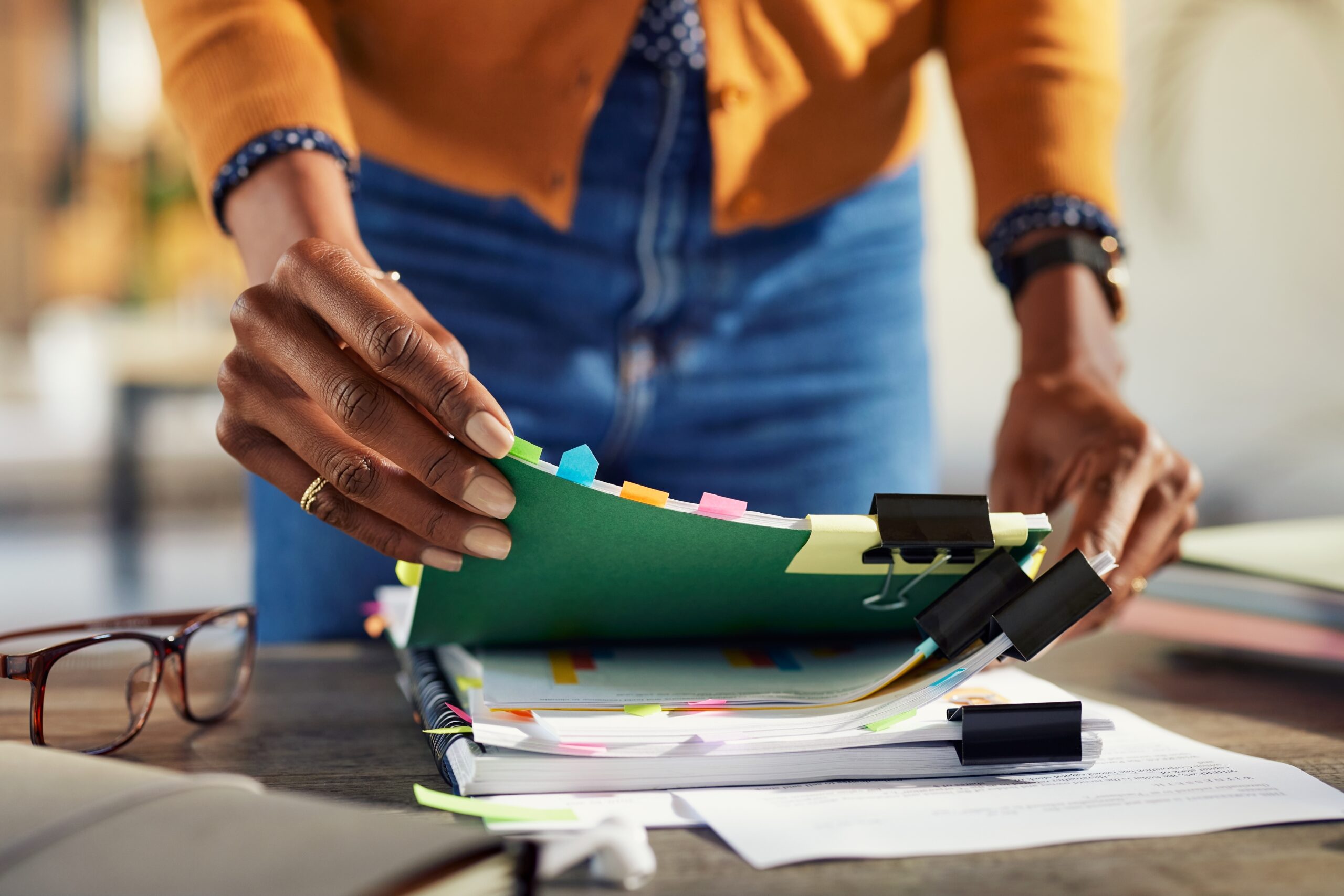 Employee,Black,Woman,Hands,Working,On,Stacks,Of,Workpaper,Files